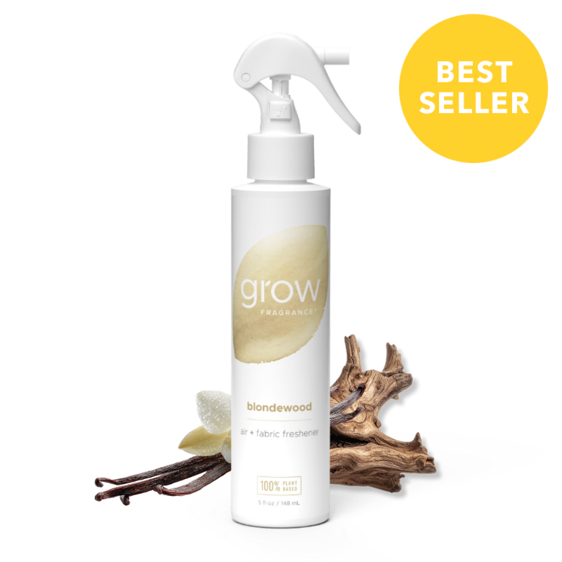 White spray bottle labeled 'grow' with blondewood scent, surrounded by wood-like elements on a white background.