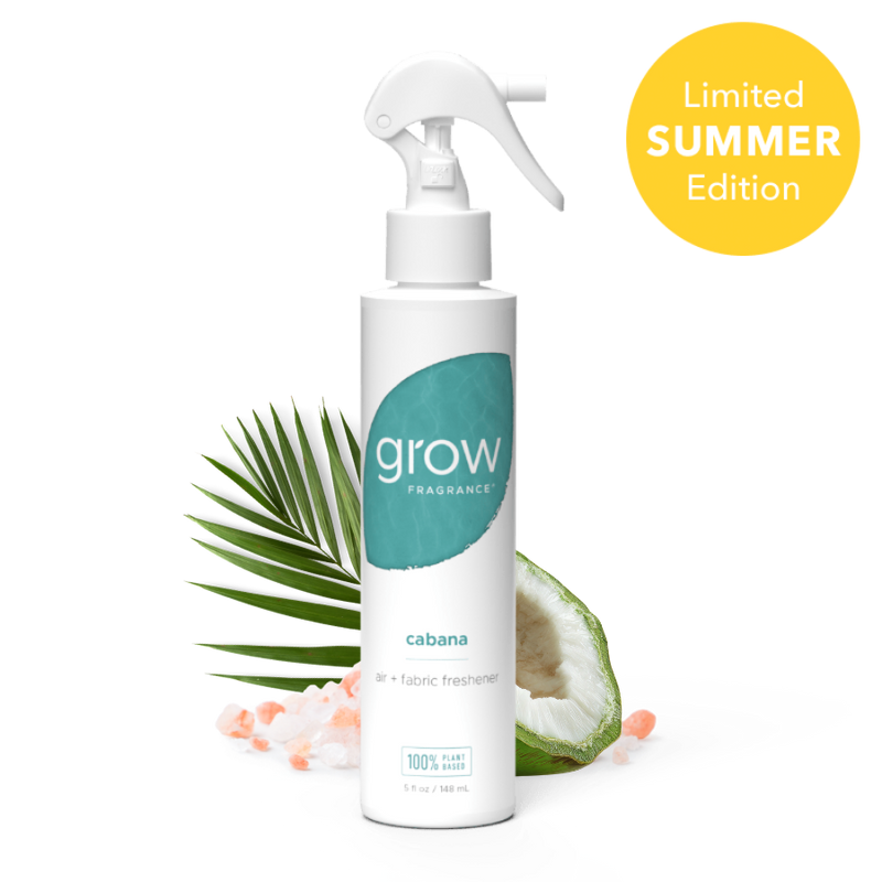 Spray bottle labeled 'grow' with a palm leaf and coconut in the background, on a white background.