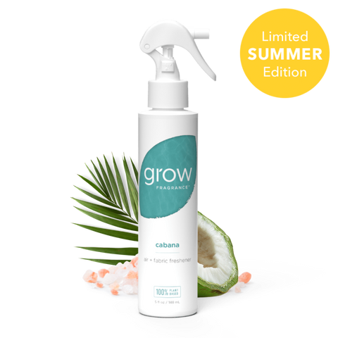 Spray bottle labeled 'grow' with a palm leaf and coconut in the background, on a white background.