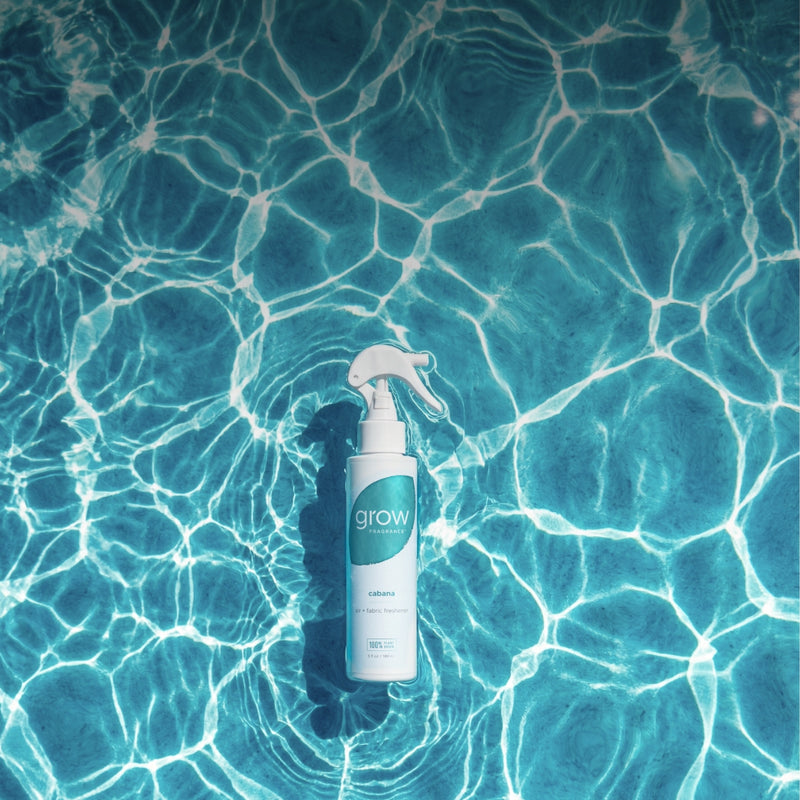 Spray bottle on a pool surface with clear water