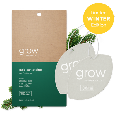 Two oval car air fresheners from grow Fragrance shown in front of their kraft paper and dark green retail card packaging, with pine branches and a yellow 'Limited Winter Edition' badge on a white background.