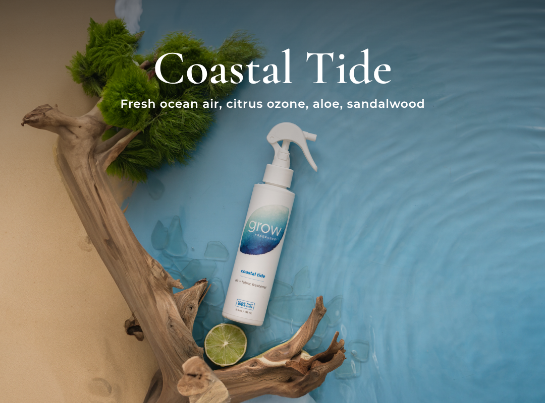 Spray bottle labeled 'Coastal Tide' with natural elements on a blue water background