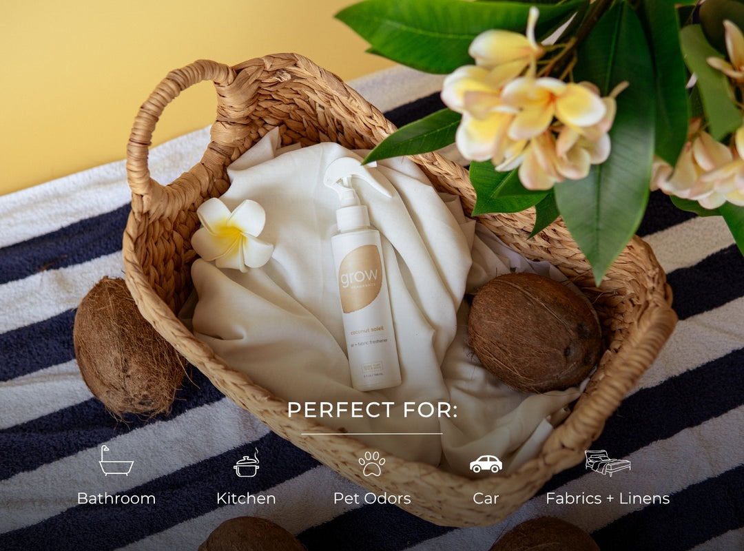 Basket with towel, Grow Fragrance Coconut Soleil air and fabric freshener, coconuts, and flowers on a striped fabric background (featured)