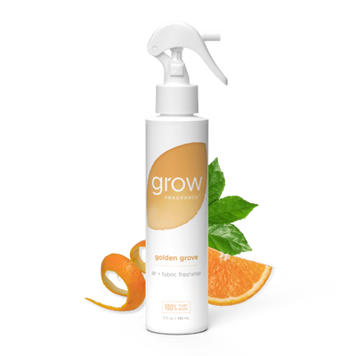 White spray bottle labeled 'grow' and golden grove with a orange label on a white background