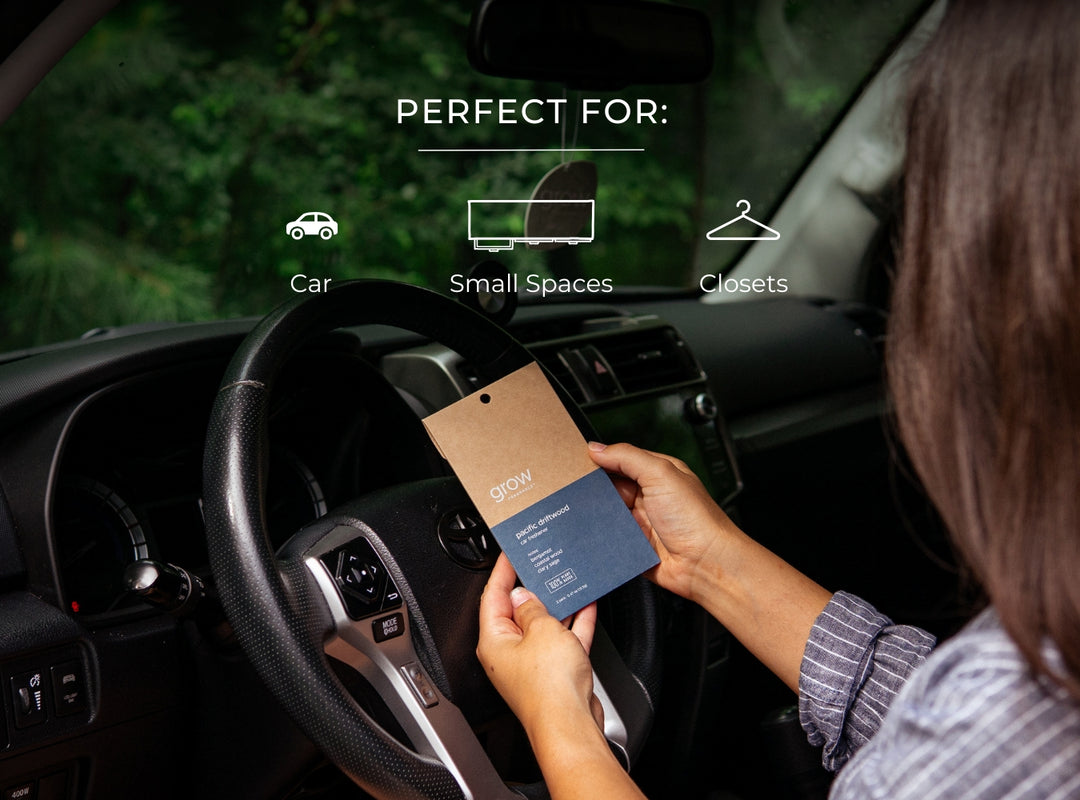 Person holding a Grow Fragrance non toxic car freshener in a car with text indicating it's perfect for car, small spaces, and closets.