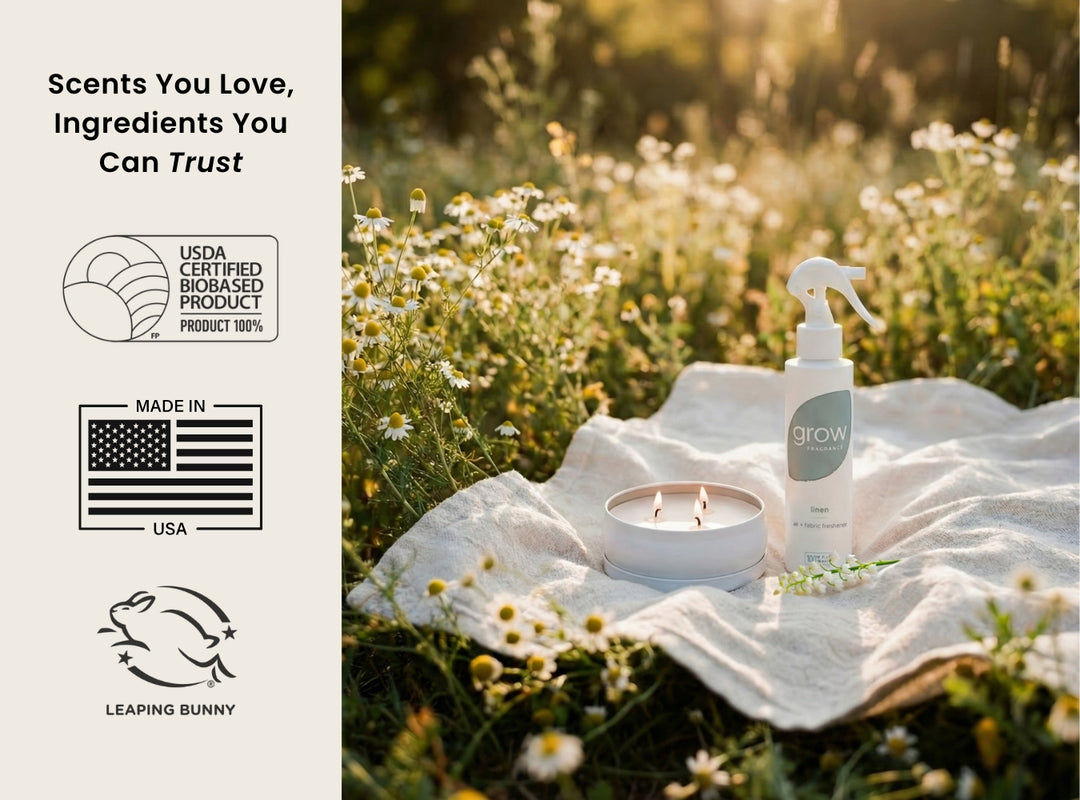 Product on a blanket in a field with branding and certification logos. Scents You Love, Ingredients You Can Trust / USDA Certified Biobased Product 100% / Made in USA / Leaping Bunny 