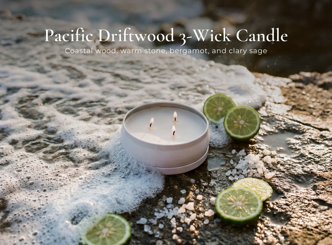 Pacific Driftwood 3-Wick Candle on a textured surface with limes and salt crystals.