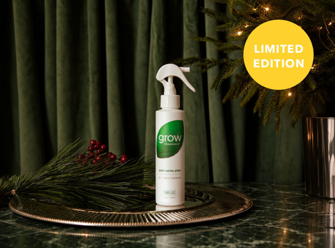 A white spray bottle of grow with a green circular logo, displayed on a gold tray with pine branches and red berries against a dark green curtain backdrop, with a yellow 'LIMITED EDITION' badge in the top right. (featured)