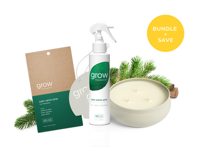 A holiday gift bundle from Grow Fragrances featuring a Palo Santo Pine candle, a matching room spray, a hanging tag, and a pine garland, arranged on a white background with a yellow 'BUNDLE + SAVE' badge. (featured)