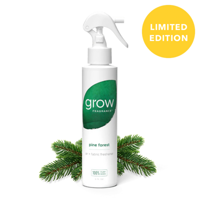 White spray bottle labeled 'grow' with a green leaf logo, surrounded by pine branches on a white background.