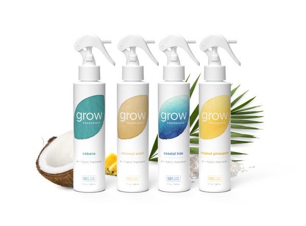 Four 'grow' fragrance bottles with different scents on a white background