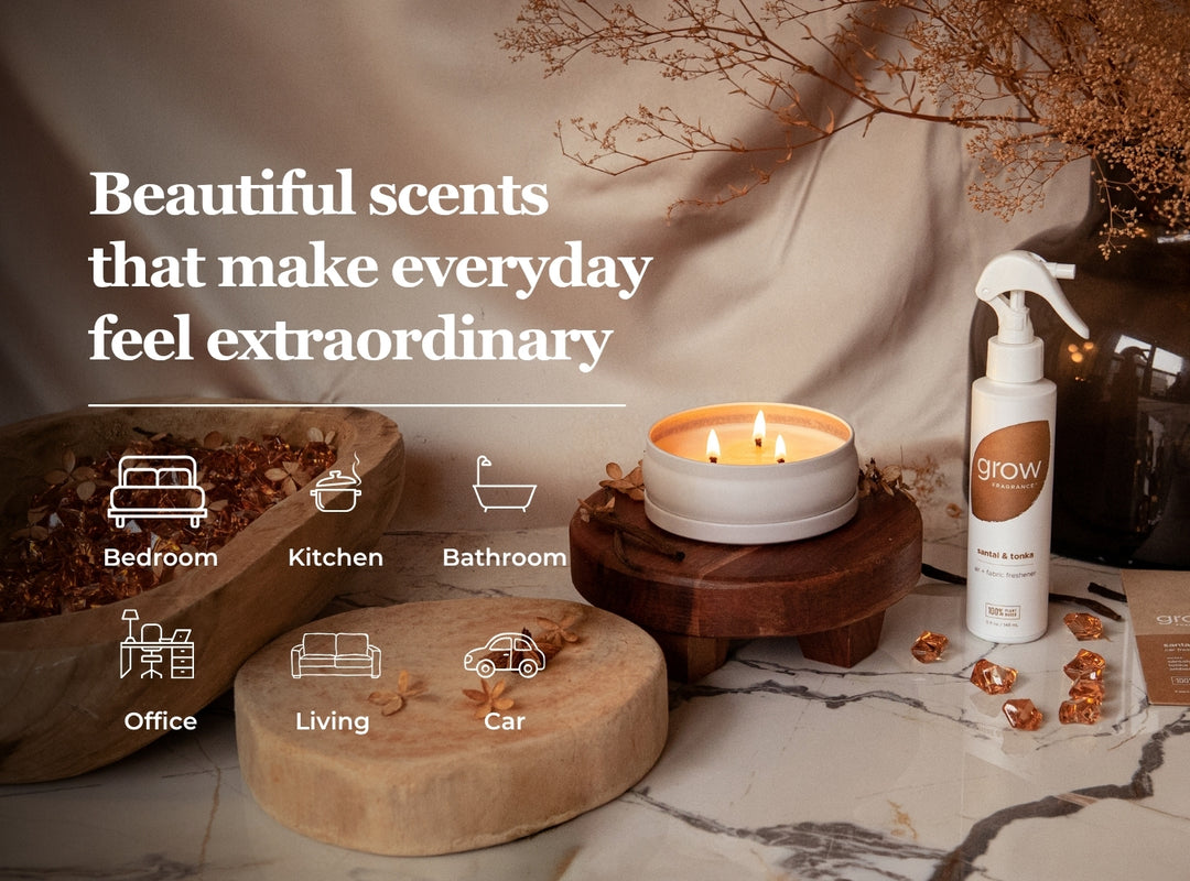 A styled product scene showing a white spray bottle labeled GROW next to a lit candle on a wooden stand, with dried botanicals and home icons overlaid with text reading 'Beautiful scents that make everyday feel extraordinary.'.