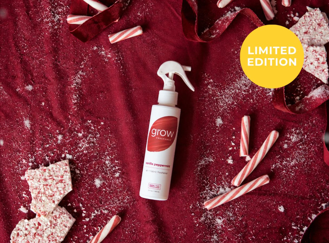 A white spray bottle labeled 'grow' and 'lightly peppermint' lies on a dark red fabric background with candy cane pieces, crushed candy bark, and ribbon. A yellow circle in the top right says 'LIMITED EDITION'. (featured)