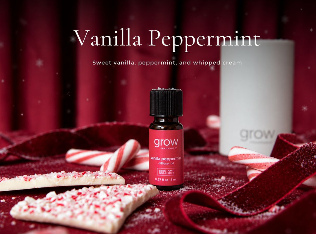 A small bottle of grow natural vanilla peppermint essential oil oil placed on a dark red velvet surface with candy canes, a white candle, and holiday-themed props. The text at the top reads 'Vanilla Peppermint' with a subtitle describing the scent. (featured)