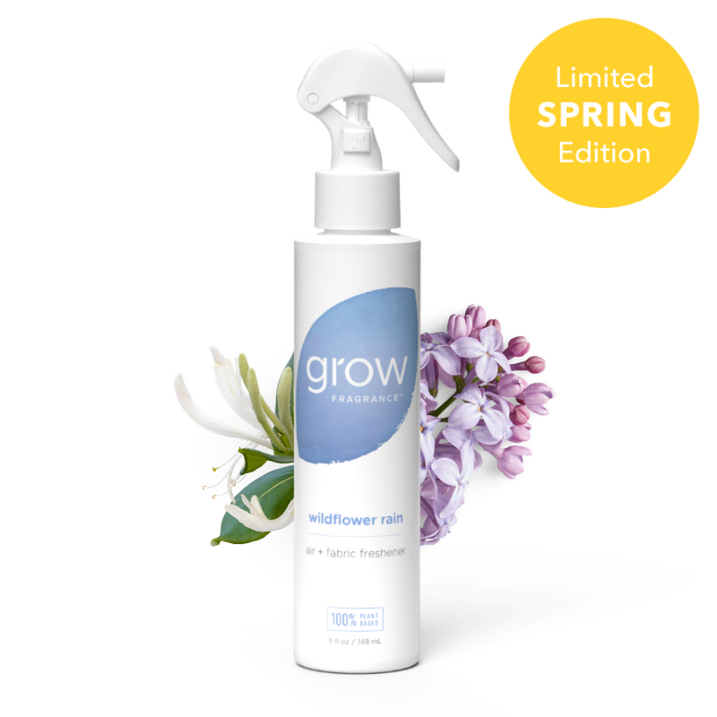 White spray bottle labeled 'grow' with a blue circular logo on a white background Label text: "grow fragrance / wildflower rain / air + fabric freshener / 100% plant based / 5 fl oz / 148 mL" + badge: "Limited Spring Edition"