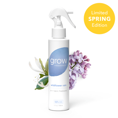 White spray bottle labeled 'grow' with a blue circular logo on a white background Label text: "grow fragrance / wildflower rain / air + fabric freshener / 100% plant based / 5 fl oz / 148 mL" + badge: "Limited Spring Edition"