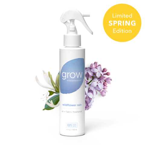 White spray bottle labeled 'grow' with a blue circular logo on a white background Label text: "grow fragrance / wildflower rain / air + fabric freshener / 100% plant based / 5 fl oz / 148 mL" + badge: "Limited Spring Edition"