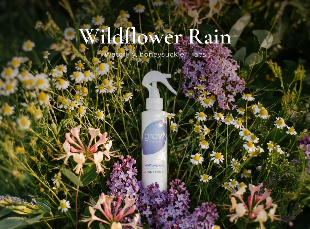 Spray bottle labeled 'grow' surrounded by wildflowers with text 'Wildflower Rain'.