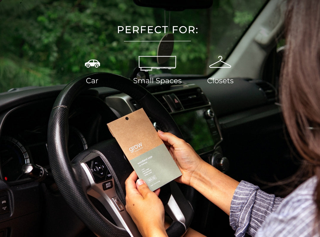 Woman holding a Woodland sage car freshener in a car with text 'Perfect For: car, small spaces, closets' displayed.