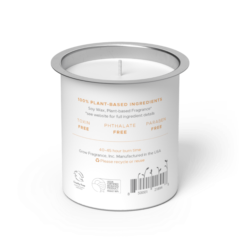 Back label of Grow Fragrance soy candle refill tin, showing 100% plant-based ingredients, toxin-free, phthalate-free, and paraben-free certifications, 40–45 hour burn time, Cruelty Free and USDA Certified Biobased Product seals, and a barcode on a white cylindrical tin with a silver rim. Grow Fragrance, Inc. Manufactured in the USA. 