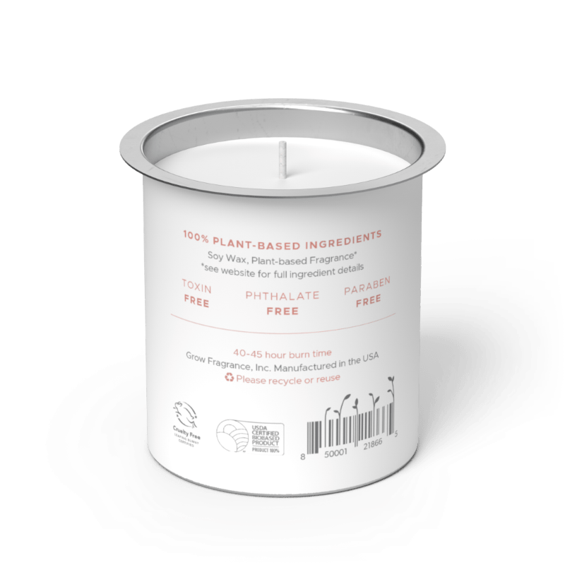 Back label of Grow Fragrance soy candle refill tin, showing 100% plant-based ingredients, toxin-free, phthalate-free, and paraben-free certifications, 40–45 hour burn time, Cruelty Free and USDA Certified Biobased Product seals, and a barcode on a white cylindrical tin with a silver rim. Grow Fragrance, Inc. Manufactured in the USA. 