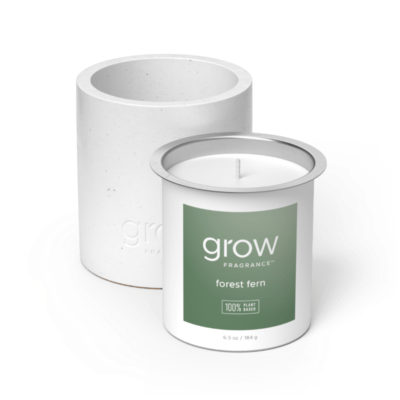 White candle with 'grow' Forest Fern fragrance label on a white background