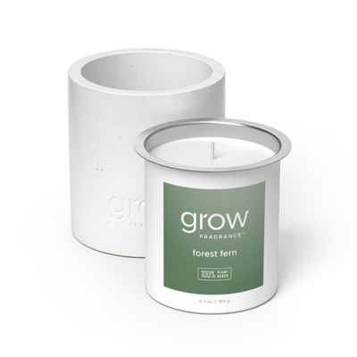 White candle with 'grow' Forest Fern fragrance label on a white background