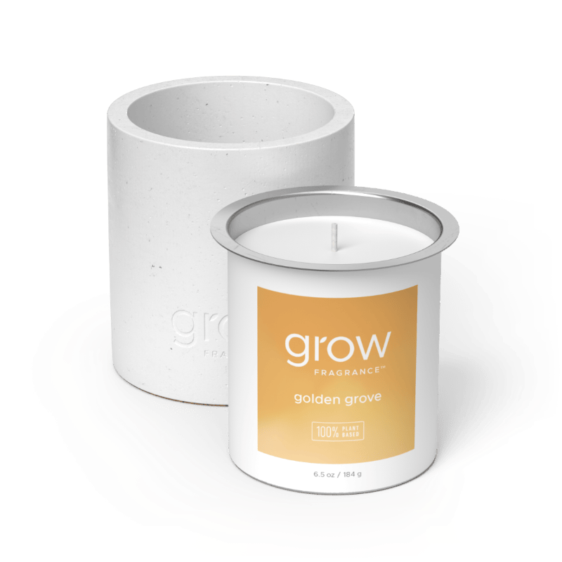 White candle with 'grow' Golden Grove Candle Set fragrance label on a white background