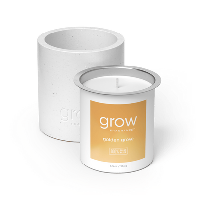 White candle with 'grow' Golden Grove Candle Set fragrance label on a white background