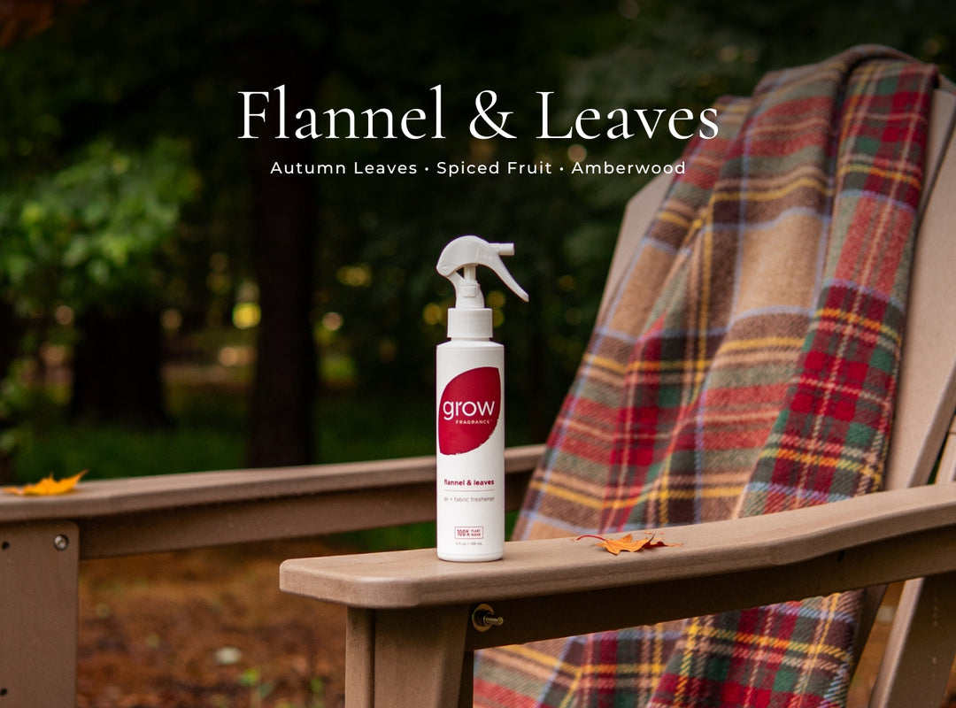 Spray bottle labeled 'grow' on a wooden chair with a plaid blanket and autumn-themed text.