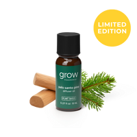 A small amber glass bottle of grow fragrance Palo Santo Pine diffuser oil with a black cap and dark green label, shown on a white background with a wooden diffuser stick, pine needles, and a yellow circle that says LIMITED EDITION.