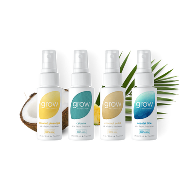Four 'grow' fragrance bottles with different scents on a white background