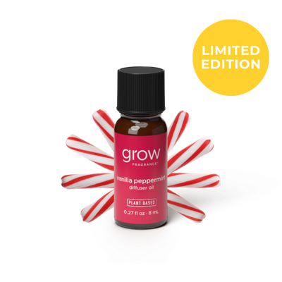 A small amber glass bottle of grow fragrance vanilla peppermint diffuser oil with a black cap and a pink label, styled with red-and-white candy canes behind it on a white background. A yellow circle in the top right says LIMITED EDITION. 