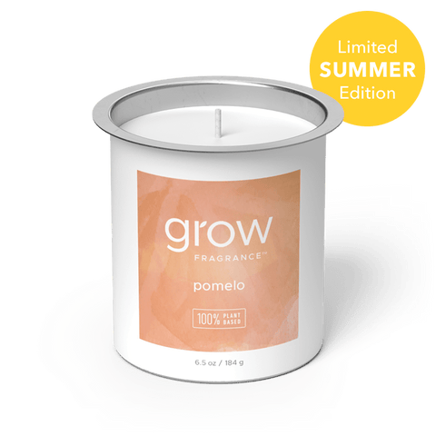 Candle with 'grow' pomelo fragrance label on a white background